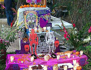 Gravesite adorned with candles and flowers