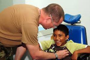 Young hispanic child being treated by doctor