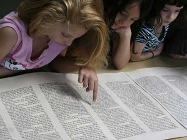 Children reading the scrolls.