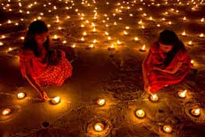 Young Indian girls lighting candles