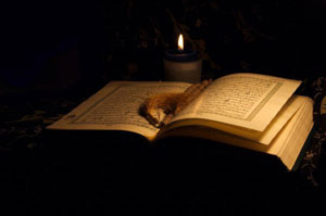 Quran with candle for reading