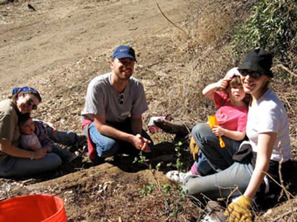 Family planting tree in Runyon Canyon.