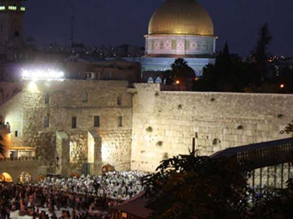 Jews praying at the western wall in Jerusalem at night for Yom Kippur.