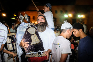 Jews celebrating in the streets with the sacred scrolls