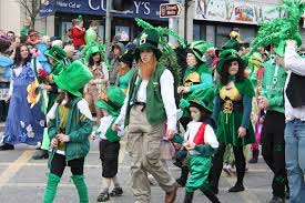 People walking in parade dressed in green with shamrocks