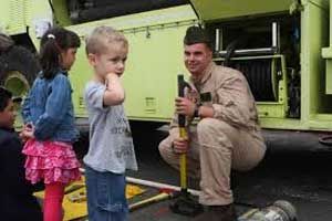 Fire fighter showing kids truck