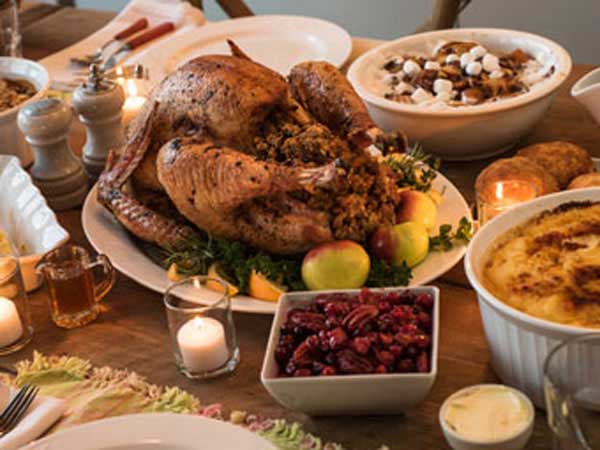 Bountiful Thanksgiving dinner with turkey, stuffing, cranberries and all the fixings.