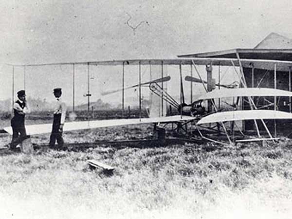 Wright brothers Orville on left and Wilbur on the right in 1904 with the Wright Flyer 2 plane at Huffman Prairie.